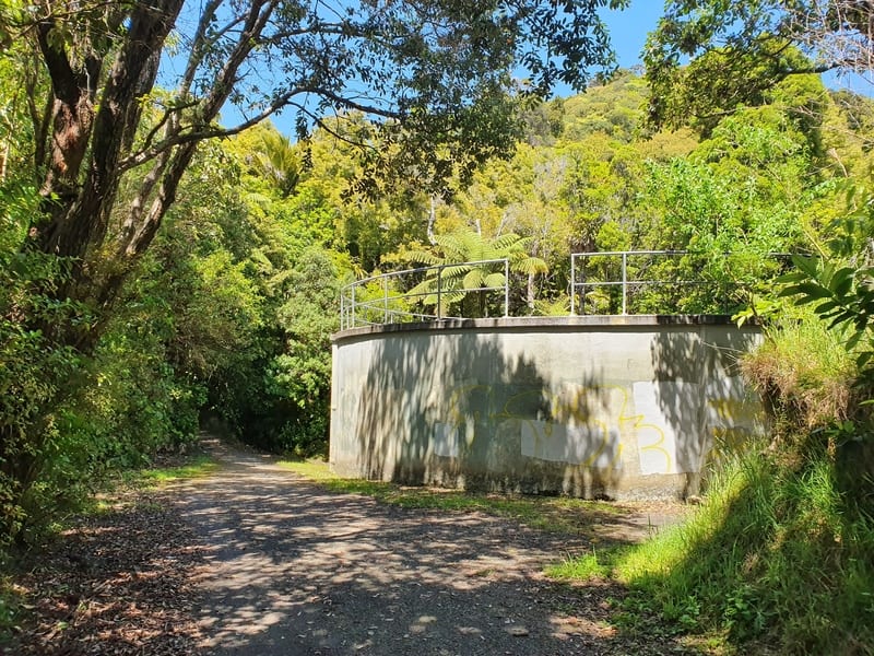a water tank and bushes on a path
