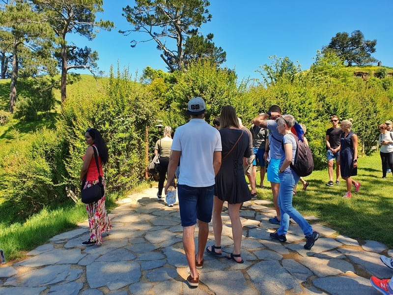 group of people standing in hobbiton