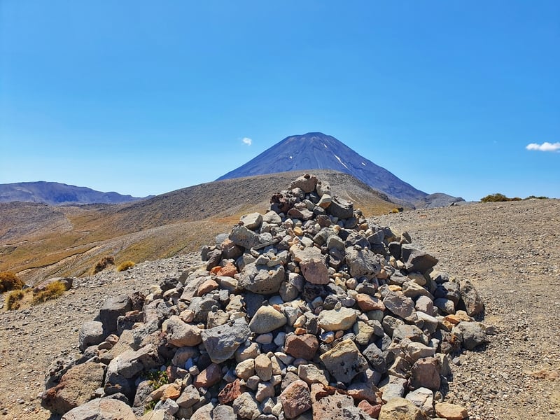 a cairn in front of a mountain