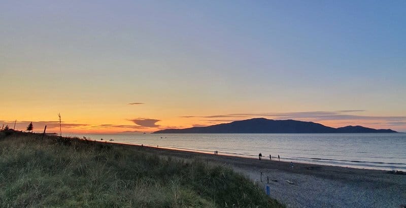 a sunset with kapiti island in the background makes it one of the best things to do in kapiti