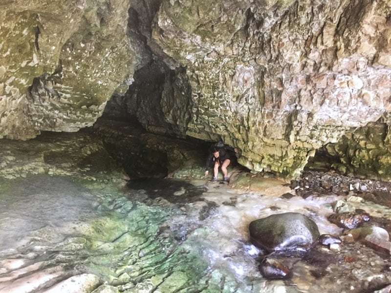 girl exiting the cave stream walk 
