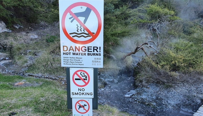 warning signs at hot water beach