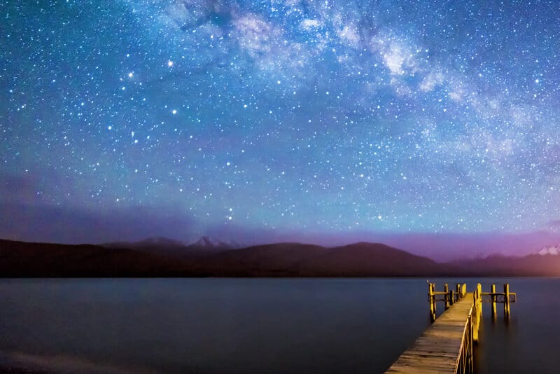 Night milkyway with wooden jetty at Te Anau, New Zealand