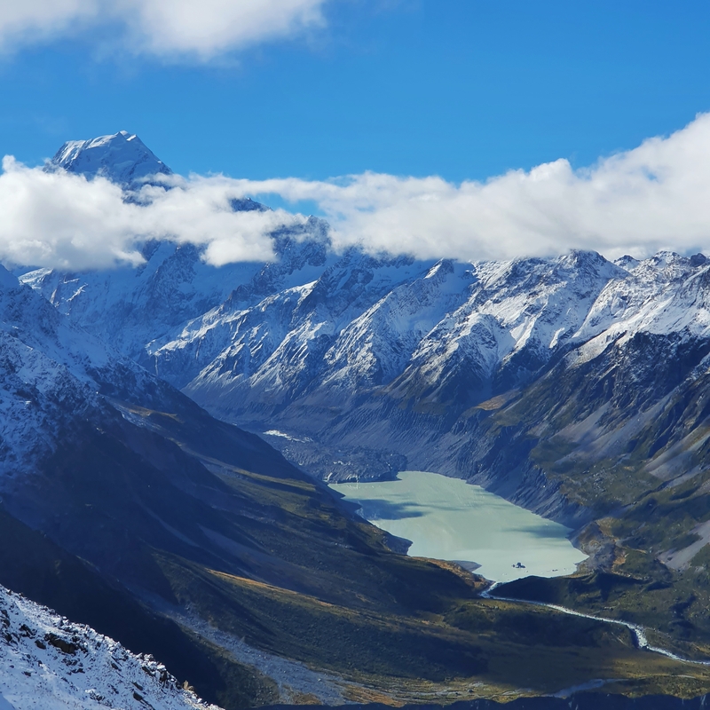 view of lake hooker and aoraki mount cook peaking out of the clouds from the mueller hut track