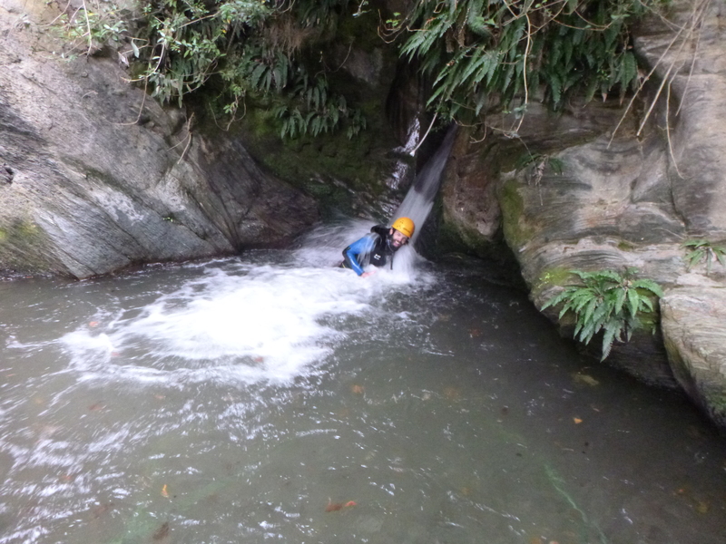 head in waterfall with new zealand canyoning