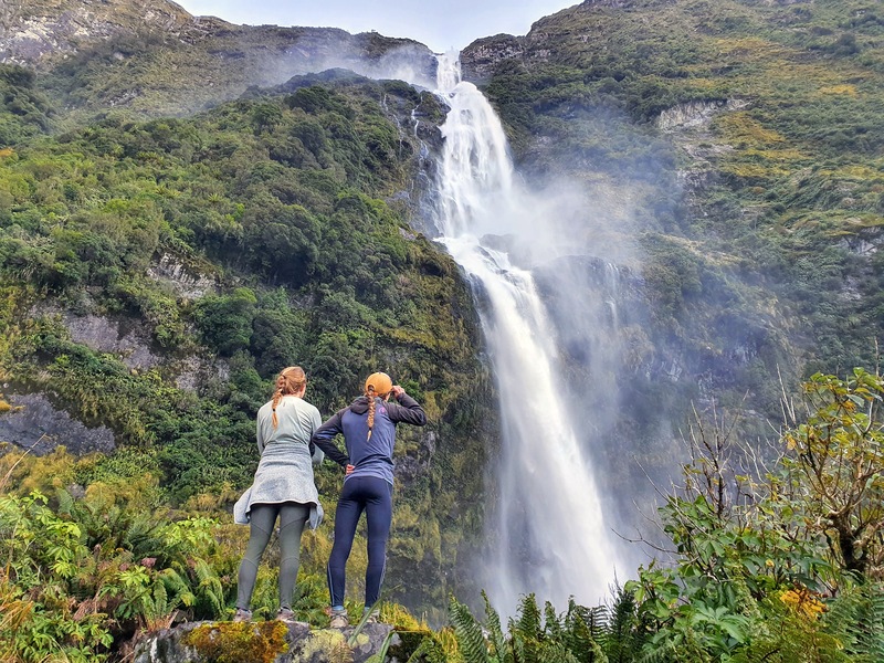 two girls looking at sutherland falls from the bottom