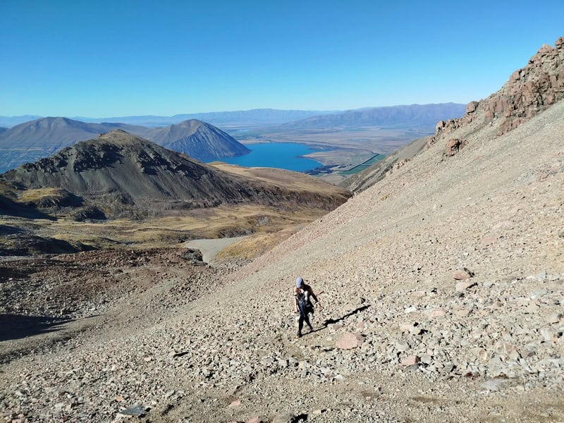 girl hiking up a scree field